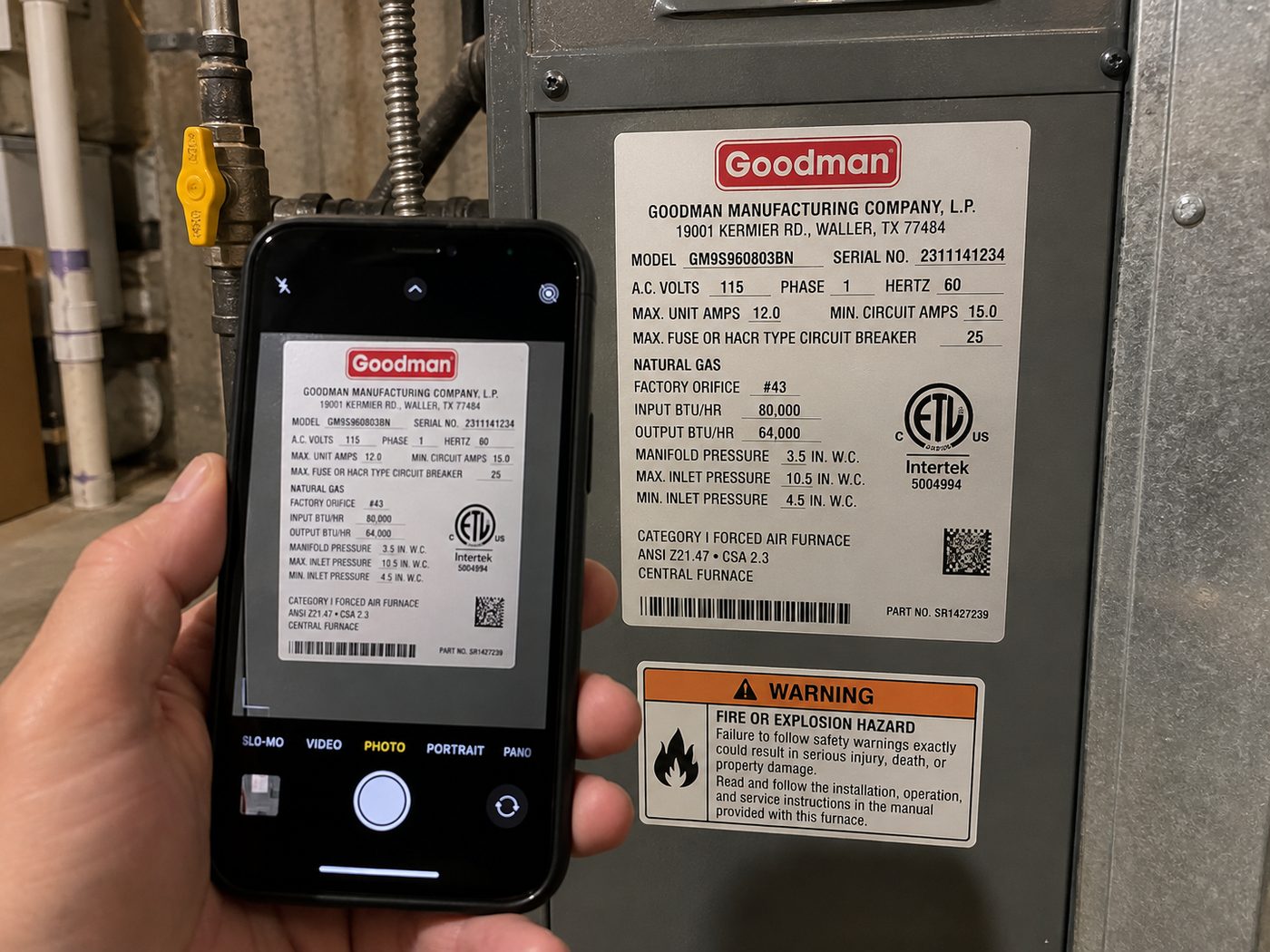 A hand holding a phone, photographing the data plate on a gas furnace